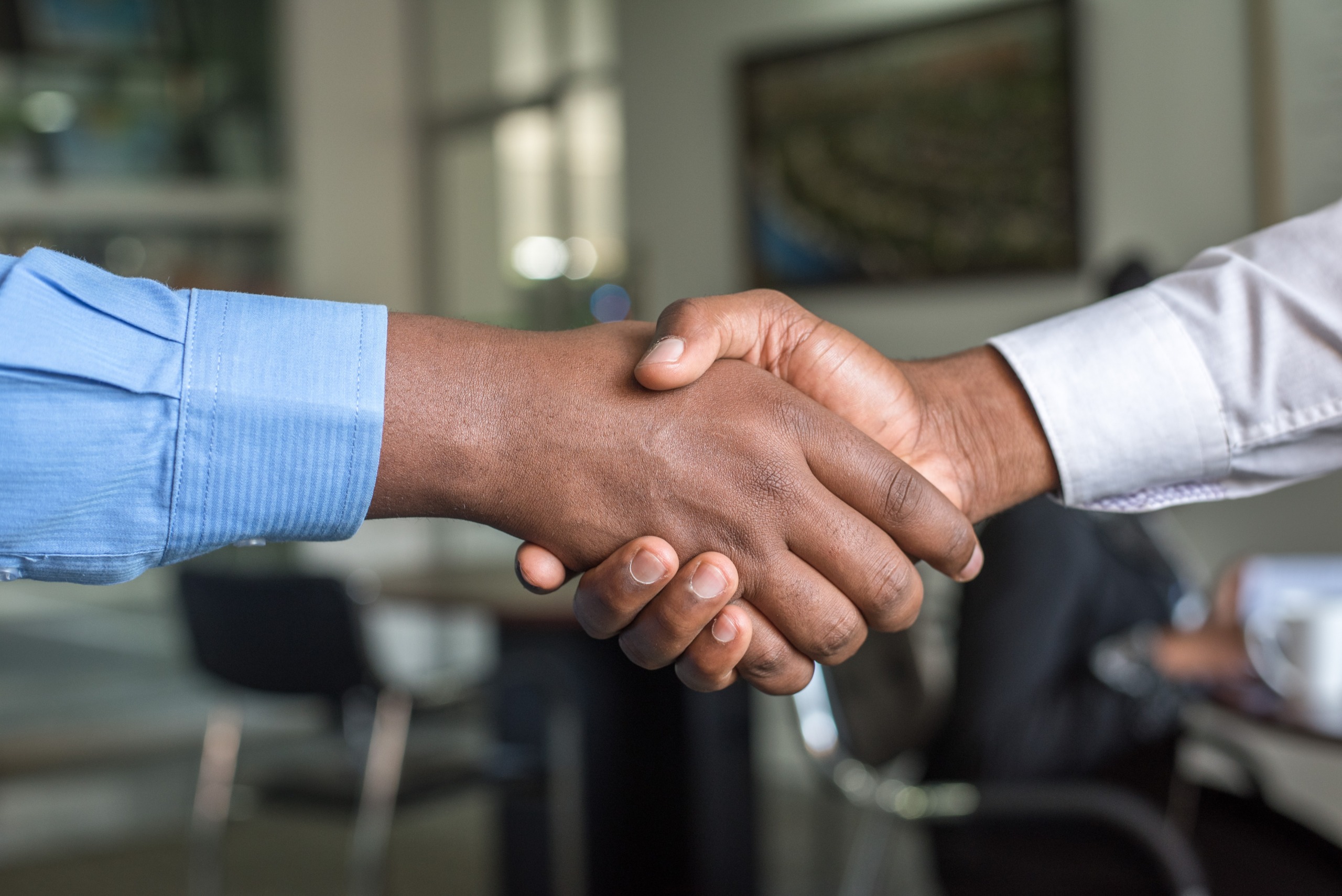 Recruitment agency staff shaking hands with a job candidate.